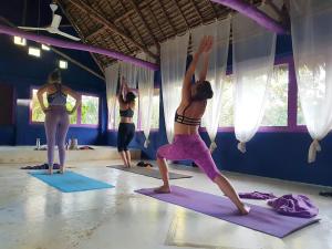 a group of women in a yoga class at Paje By Night Bungalows in Paje