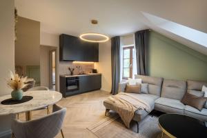 a living room with a couch and a table at Kalan Boutique Stay in Žirovnica