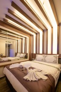 a bedroom with a large bed with a large window at hotel di poesia deluxe in Istanbul