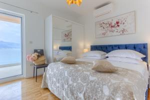 a bedroom with two beds and a large window at Villa ARIJANA - LAVANDA in Slatine