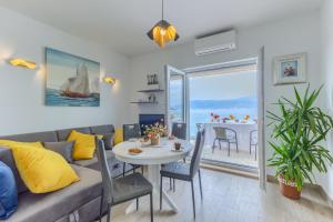 a living room with a couch and a table at Villa ARIJANA - LAVANDA in Slatine