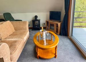 a living room with a couch and a coffee table at Glen Lodges Rogart in Rogart