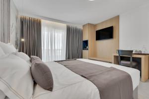 Posteľ alebo postele v izbe v ubytovaní Hotel Laurentum