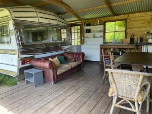 a living room with a couch in an rv at The Quarry Caravan in Falmouth