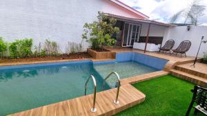 a swimming pool in the backyard of a house at Nostravila in Lonavala