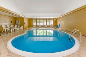 a pool in the middle of a room with chairs at Comfort Inn Wytheville - Fort Chiswell in Wytheville