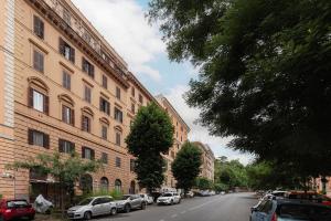 a street with cars parked on the side of a building at Trastevere Three Cozy Rooms in Rome