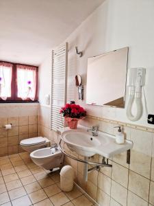 a bathroom with a sink and a toilet and a mirror at L'Incontro B&B Santeramo in Santeramo in Colle +67 photos
