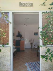 an office with a door open to a waiting room at Riverside Αpartments in Vasiliki