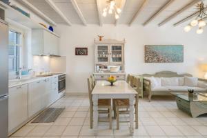 a kitchen and living room with a table and a couch at Blue Coral 1 in Isterni
