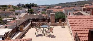 a patio with two chairs and a table on a balcony at Vouno Village in Vounós