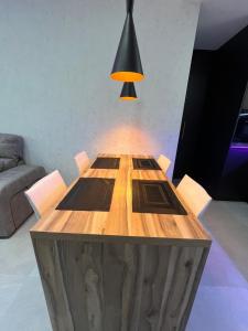 a wooden table in a room with a lamp at Lujo en el centro con parking privado 1 in Adra +31 photos