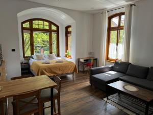 a living room with a bed and a couch at Apartamenty Żeromskiego 8 in Ustka