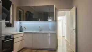 a kitchen with white cabinets and a sink at Villa F in Vrgorac - Makarska in Vrgorac