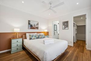 a bedroom with a bed and a ceiling fan at TwentyTwo on Twynam in Jindabyne