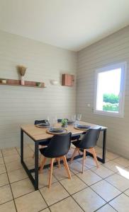 a dining room with a table and two chairs at Maison d'architecte in Cébazat