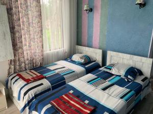 two beds sitting next to each other in a bedroom at ARGO Shekvetili in Shekhvetili