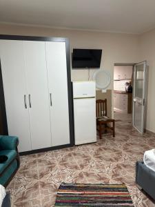 a living room with white cabinets and a couch at Old Del Mar in Vlorë