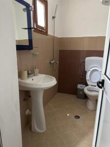 a bathroom with a sink and a toilet at Old Del Mar in Vlorë