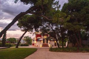 a red and white house with trees in front of it at Maison Giannino in Bari