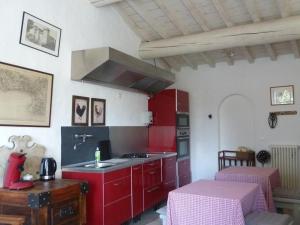 a kitchen with red cabinets and a sink in it at Mas de la Forge in Arles
