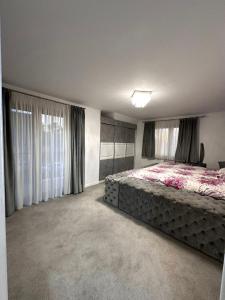 a bedroom with a large bed in a room at Vacation home in Marginea