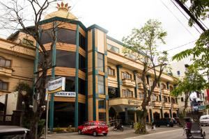 a red car parked in front of a building at Crown Royale Hotel in Balanga