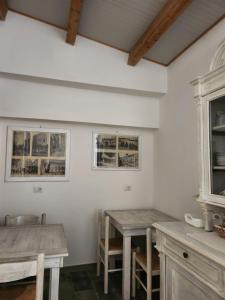 a dining room with two wooden tables and chairs at Aliga in Alghero