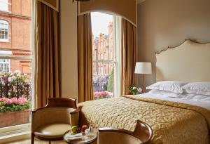 a bedroom with a bed and a large window at Egerton House in London +143 photos