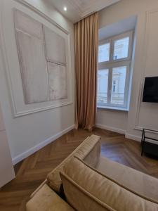 a living room with a couch and a window at Apartamenty Inspiracja in Kraków