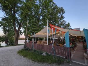 a market with a tent with people sitting under it at Apartment close to Sziget festival in Budapest