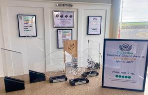 a display of trophies and certificates on a wall at The Fossil Tree Hotel in Blackpool