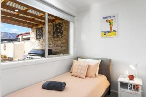 a small bedroom with a bed and a window at Spacious 4-BR Family Home in Cowes