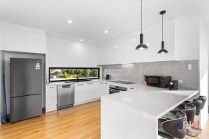 a kitchen with white appliances and a white counter top at Panoramic Paradise 4-BR San Remo in San Remo