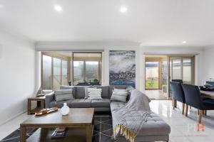 a living room with a couch and a table at Spacious 4-BR Family Home in Cowes