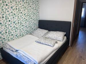 A bed or beds in a room at Keszthely Apartman