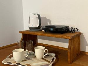 a table with a printer and two cups on it at Village Holidays - Chelonaria in Chrani