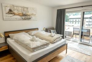 a bedroom with a bed and a large window at Ferienwohnung Gföller in Döbriach