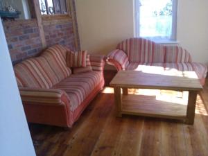 a living room with two couches and a coffee table at Schöne Ferienwohnung in Putbus in Putbus