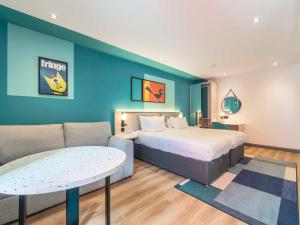 a hotel room with a bed and a couch at Holyrood Aparthotel in Edinburgh