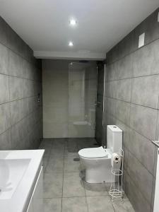 a bathroom with a toilet and a sink at Coura Lodge in Paredes de Coura +17 photos