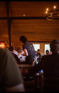a woman standing at a table in a crowd of people at Åkulla Outdoor Resort in Rolfstorp +55 photos
