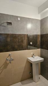 a bathroom with a sink and a shower at Paldan Orchids in Leh