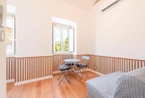 a bedroom with a table and two chairs in it at GuestReady - Urban Garden Apartments in Lisbon