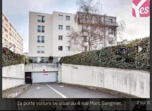 a parking lot in front of a white building at Paris Métro 7 Parking gratuit in Villejuif