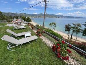 a couple of chairs and a table and a beach at Kallithea in Iraklitsa