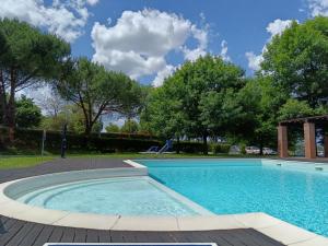a swimming pool in a yard with trees at la casa di Debora in Arezzo