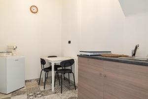 a kitchen with a small table and two chairs at Sg Apartment Standard Plus in Massafra
