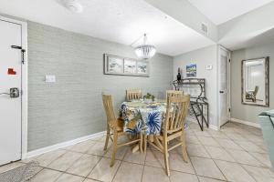 a dining room with a table and chairs at Plantation Dunes Condos in Gulf Shores