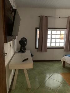 a room with a white table and a window at Casa vicentina in Tiradentes